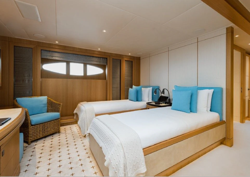 a room with a bed and a chair aboard VENTUM MARIS Yacht for Charter