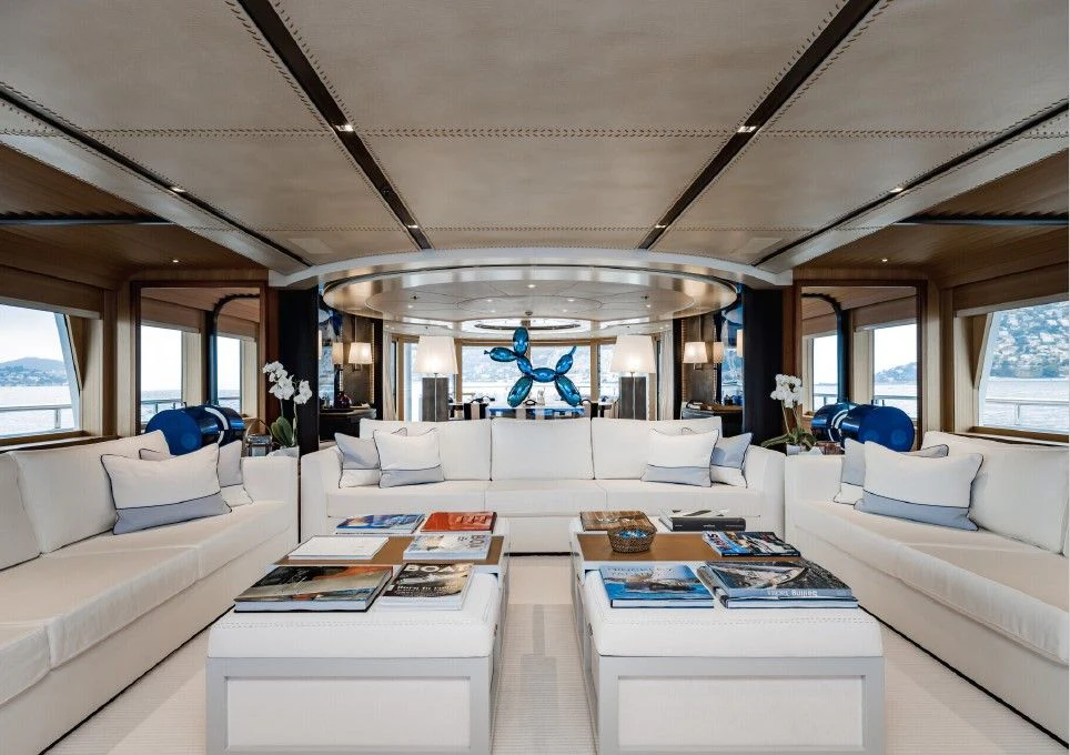 a white living room with a large window aboard VENTUM MARIS Yacht for Charter