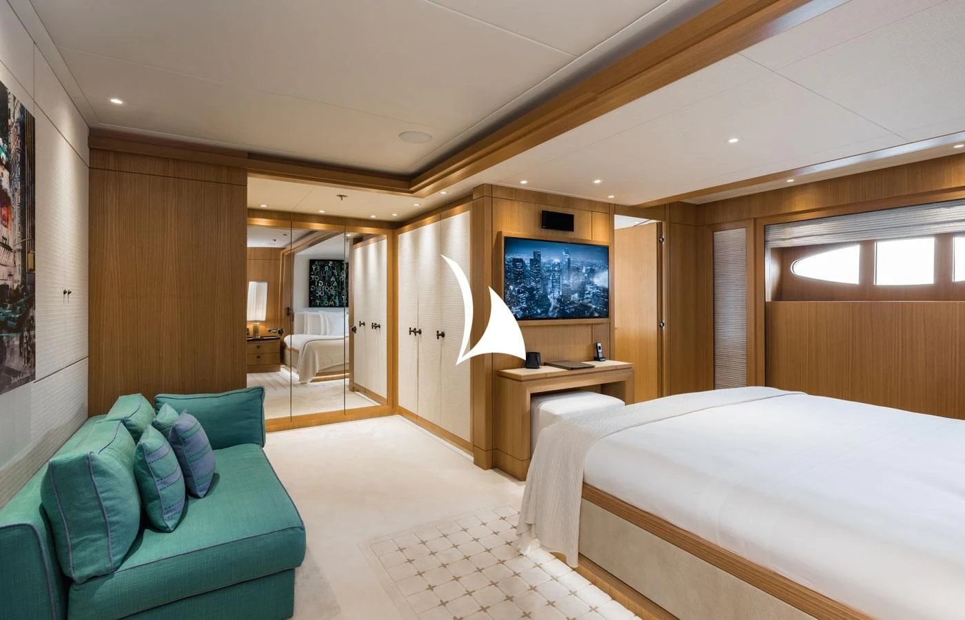 a room with a bed and a television aboard VENTUM MARIS Yacht for Charter