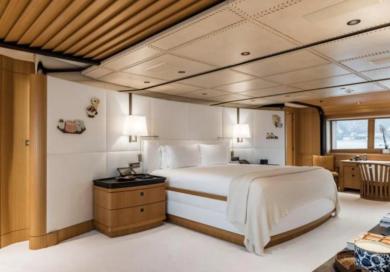 a bedroom with a bed and a table aboard VENTUM MARIS Yacht for Charter