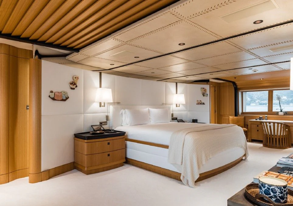 a bedroom with a bed and a table aboard VENTUM MARIS Yacht for Charter