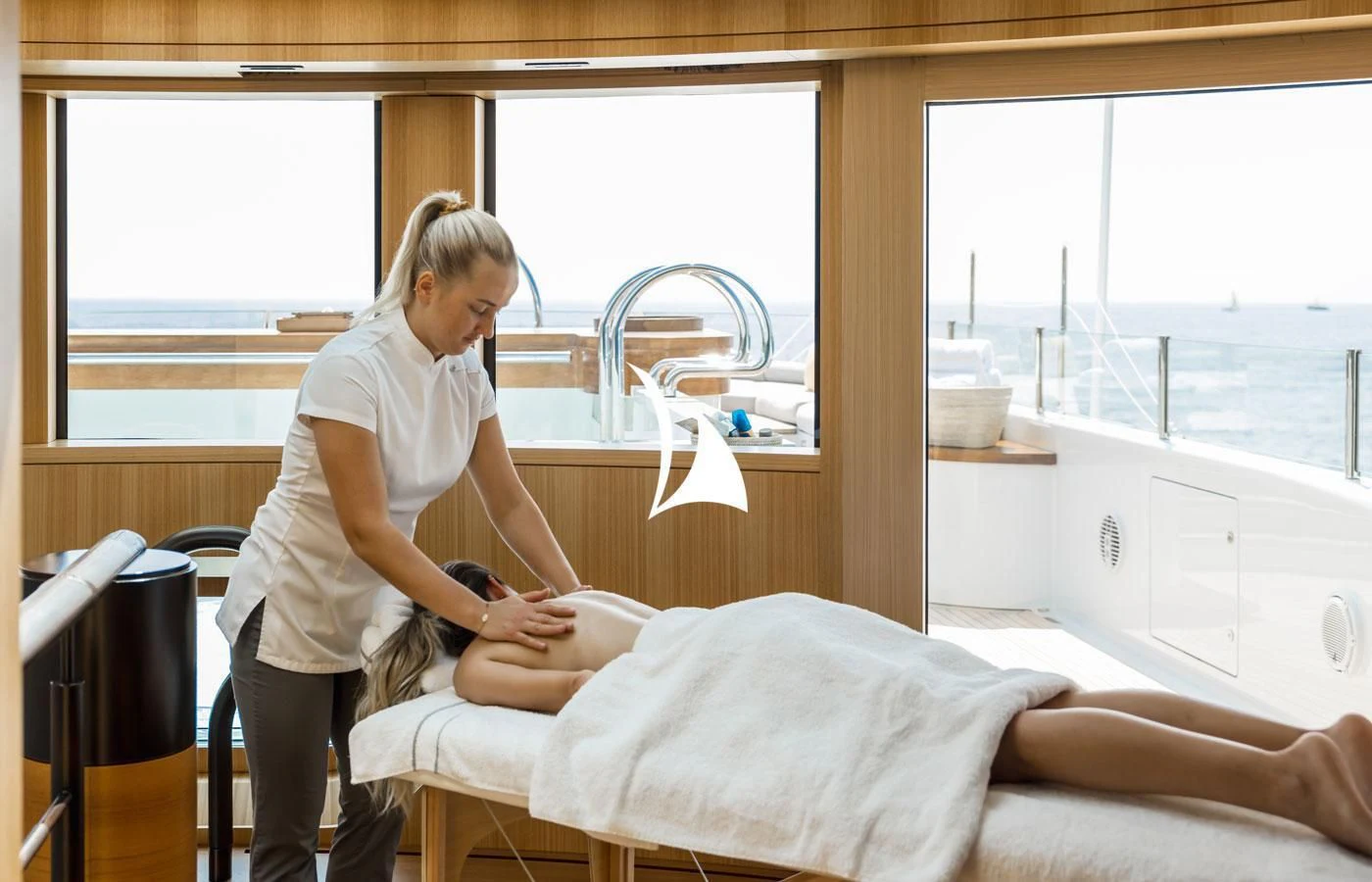 a woman sitting on a bed aboard VENTUM MARIS Yacht for Charter