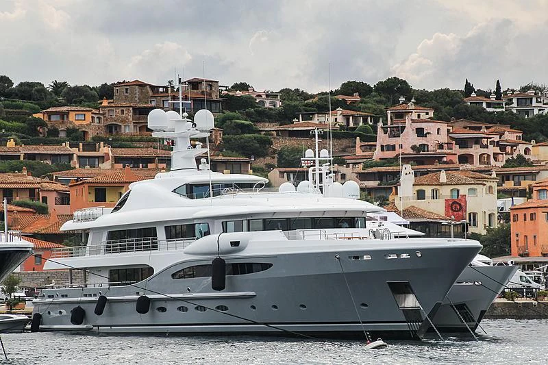 a large white boat in a harbor aboard VENTUM MARIS Yacht for Charter