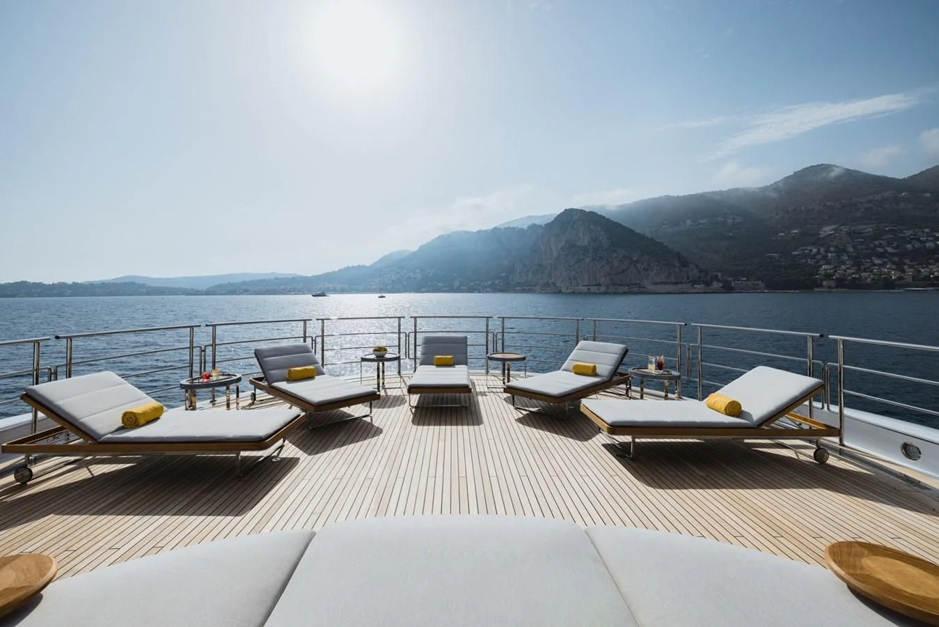 a deck with a view of the mountains and water aboard VENTUM MARIS Yacht for Charter