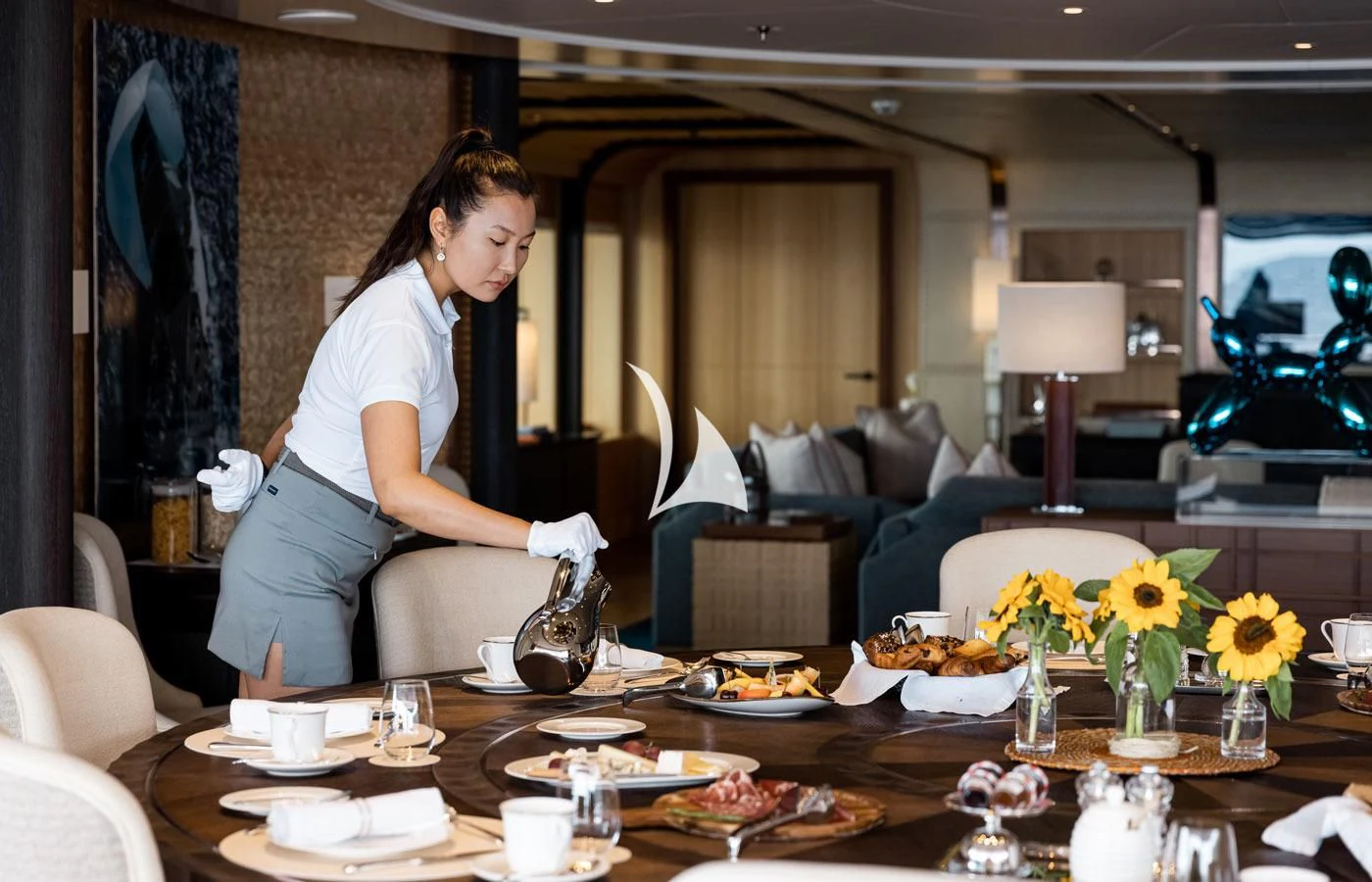 a woman standing in a living room aboard VENTUM MARIS Yacht for Charter