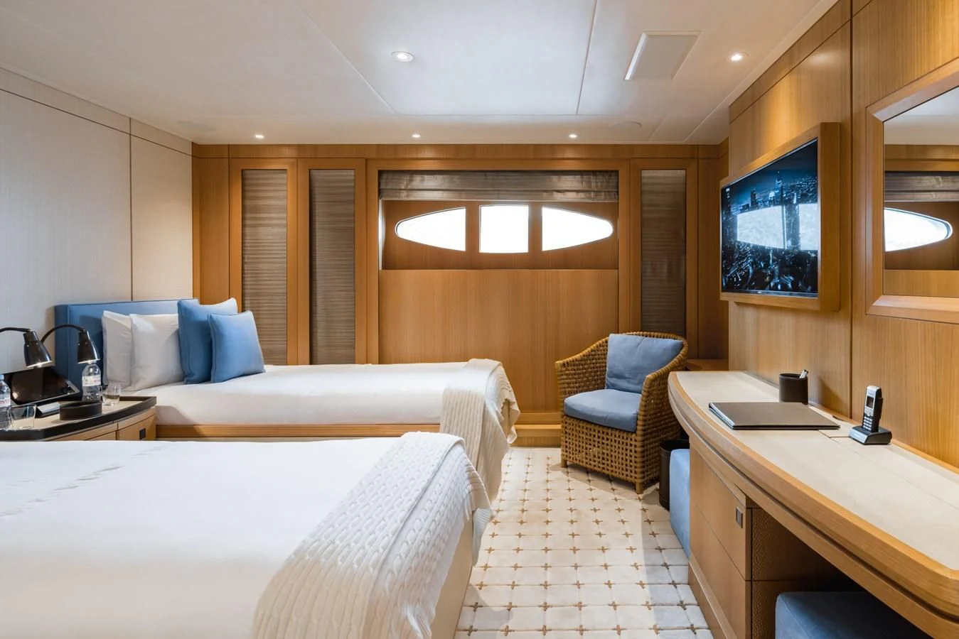 a room with a bed and desk aboard VENTUM MARIS Yacht for Charter