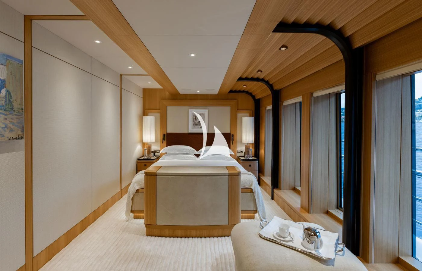a bedroom with a bed and a lamp aboard VENTUM MARIS Yacht for Charter