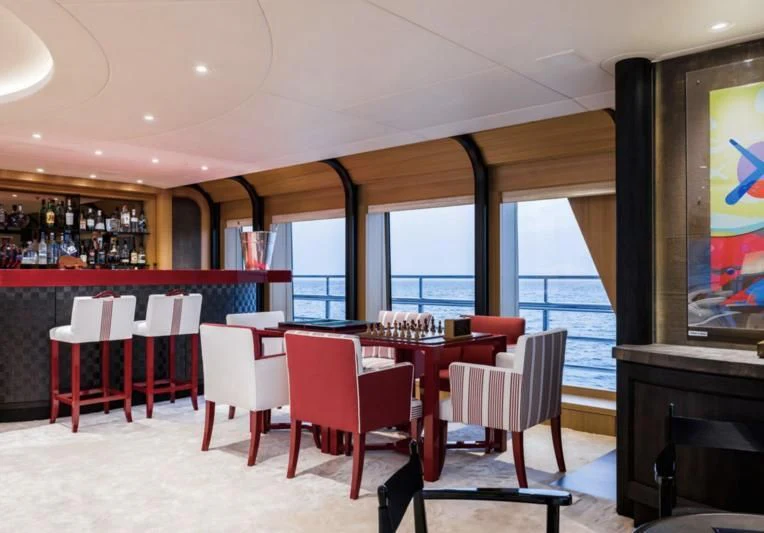 a restaurant with red tables and chairs aboard VENTUM MARIS Yacht for Charter