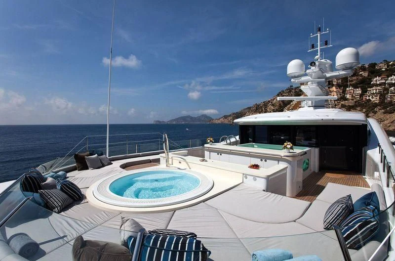 a pool on a deck overlooking a body of water aboard VENTUM MARIS Yacht for Charter