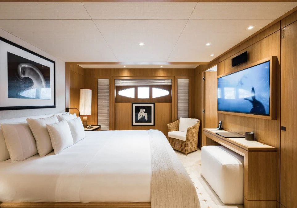 a hotel room with a bed and a tv aboard VENTUM MARIS Yacht for Charter