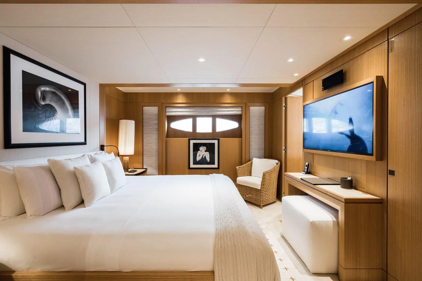a hotel room with a bed and a tv aboard VENTUM MARIS Yacht for Charter