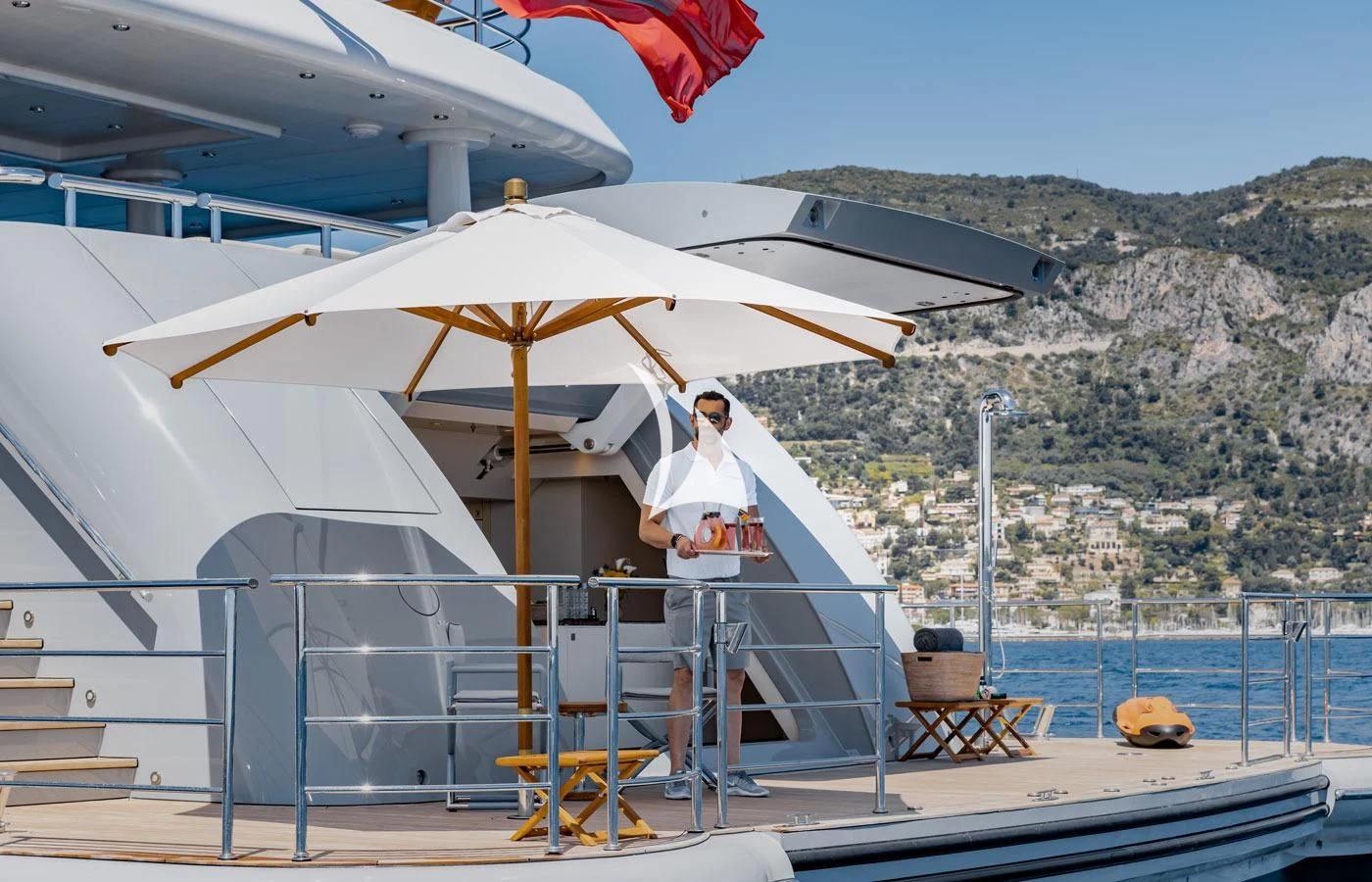 a person stands under an umbrella aboard VENTUM MARIS Yacht for Charter