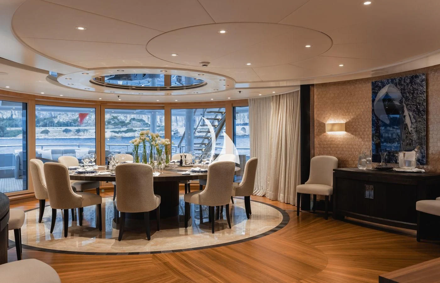 a large room with a table and chairs aboard VENTUM MARIS Yacht for Charter