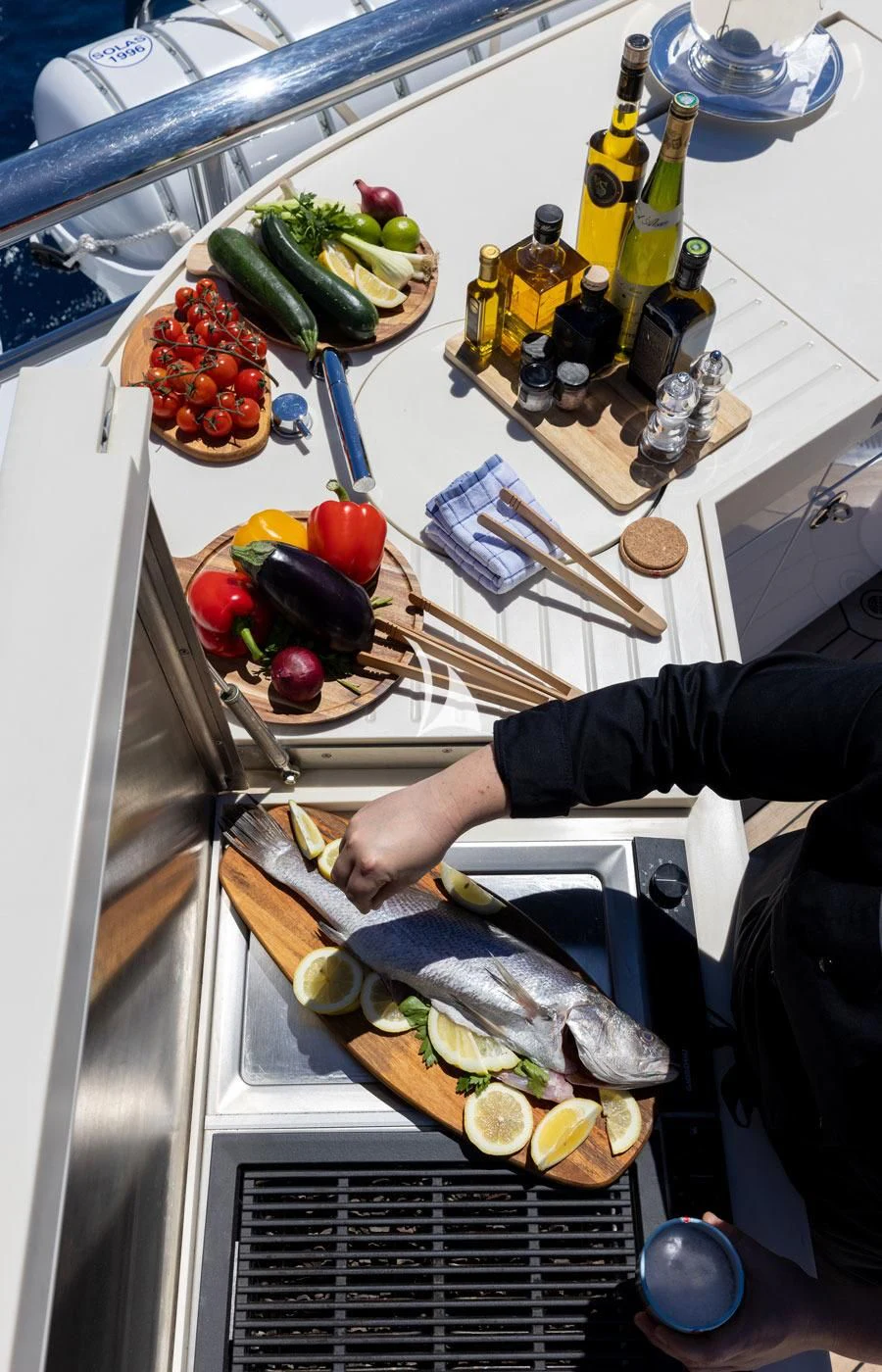 a person putting food in an oven aboard VENTUM MARIS Yacht for Charter