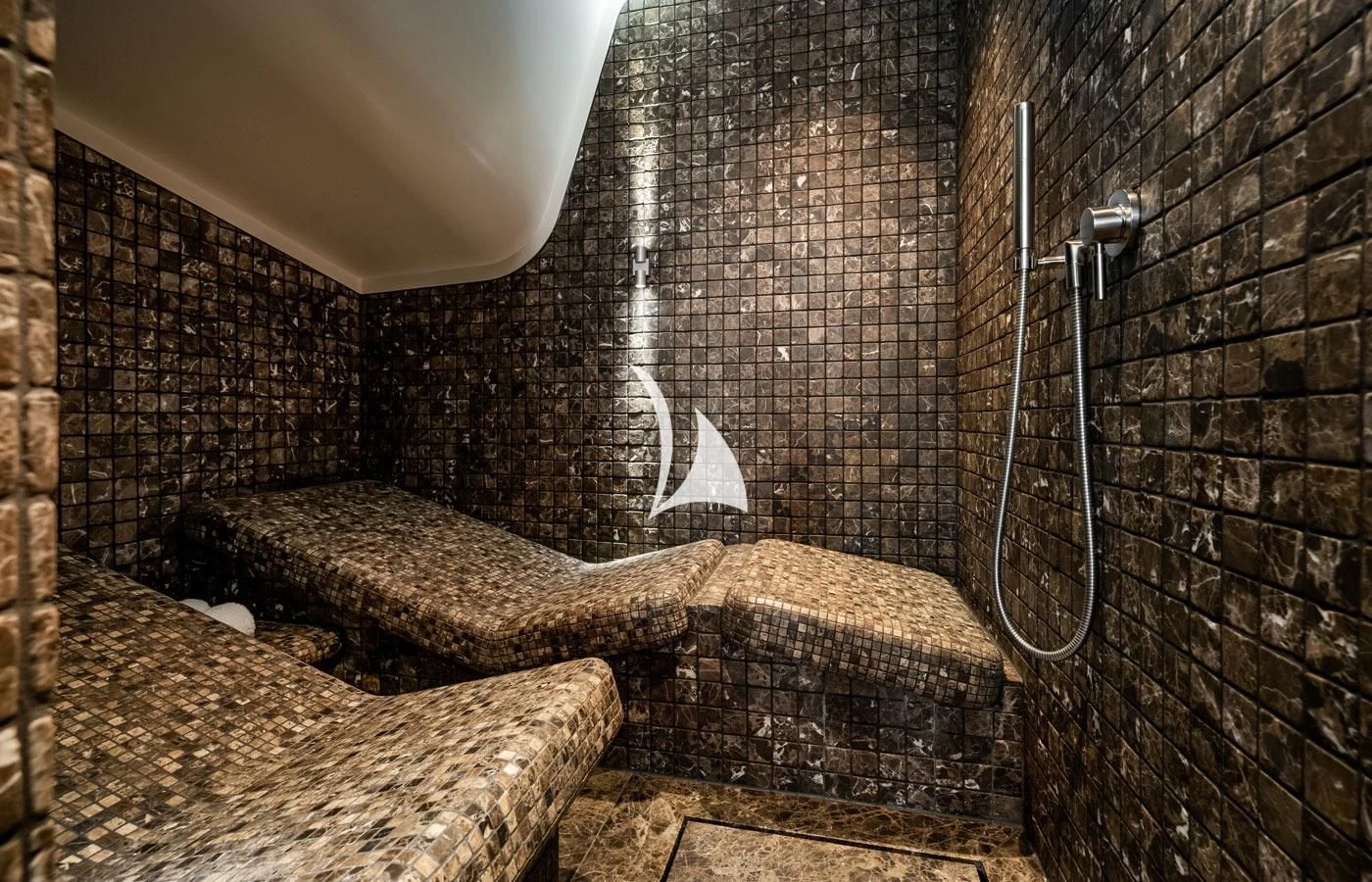 a stone bathroom with a stone shower aboard VENTUM MARIS Yacht for Charter