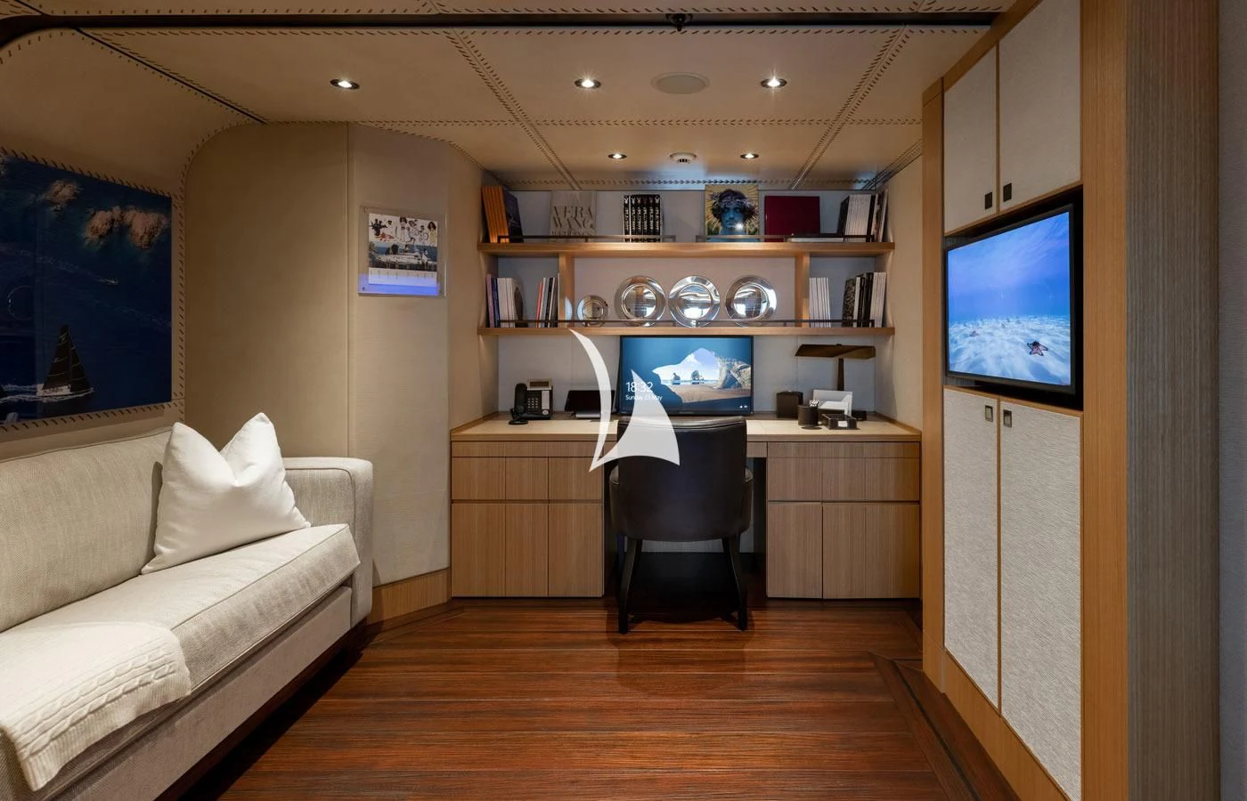 a room with a desk and a tv aboard VENTUM MARIS Yacht for Charter
