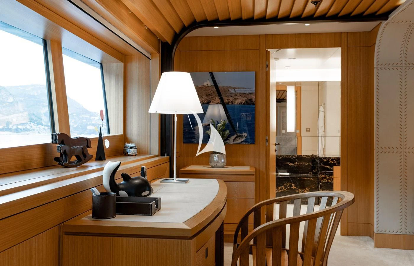 a room with a desk and a lamp aboard VENTUM MARIS Yacht for Charter