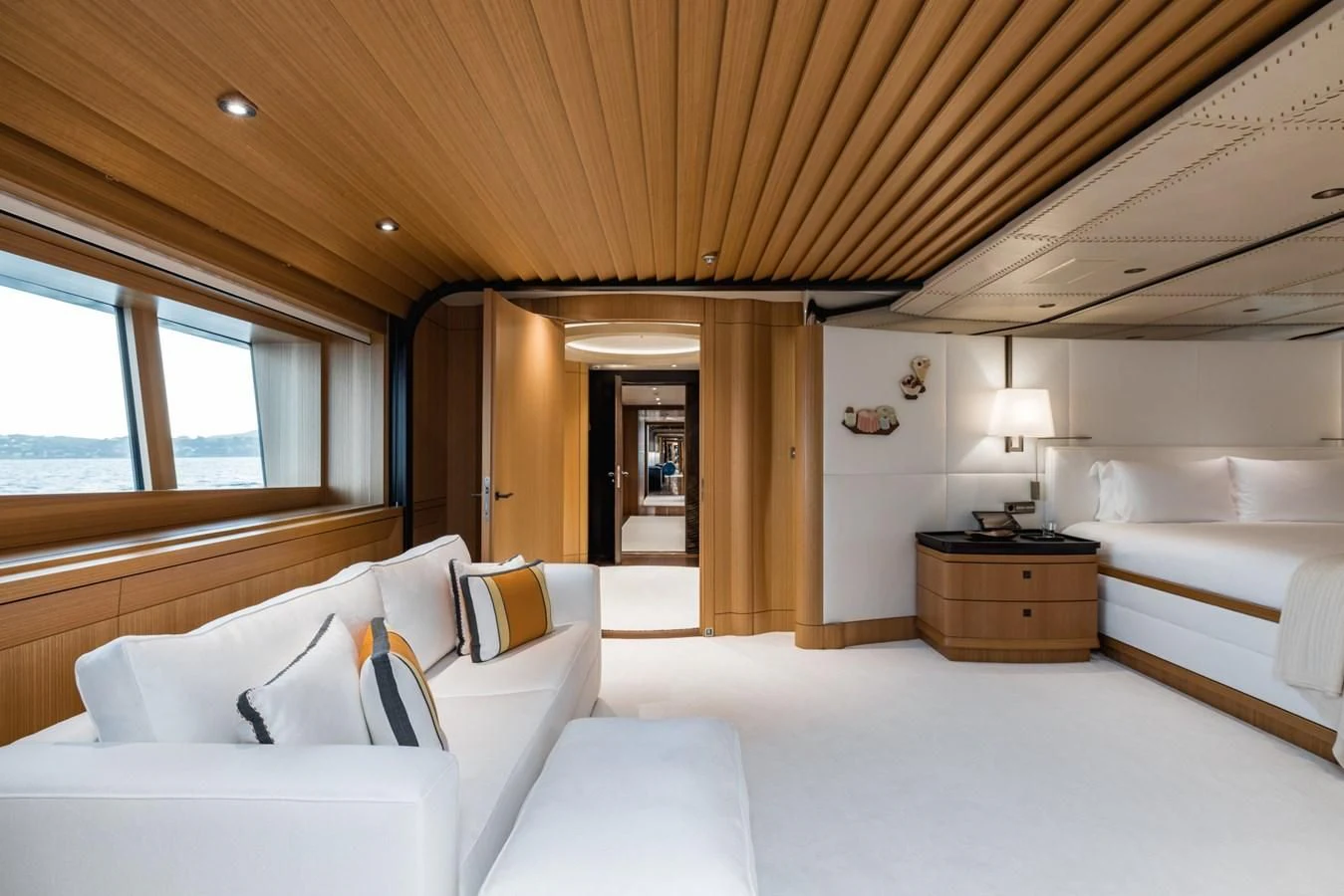 a bedroom with a bed and a large window aboard VENTUM MARIS Yacht for Charter