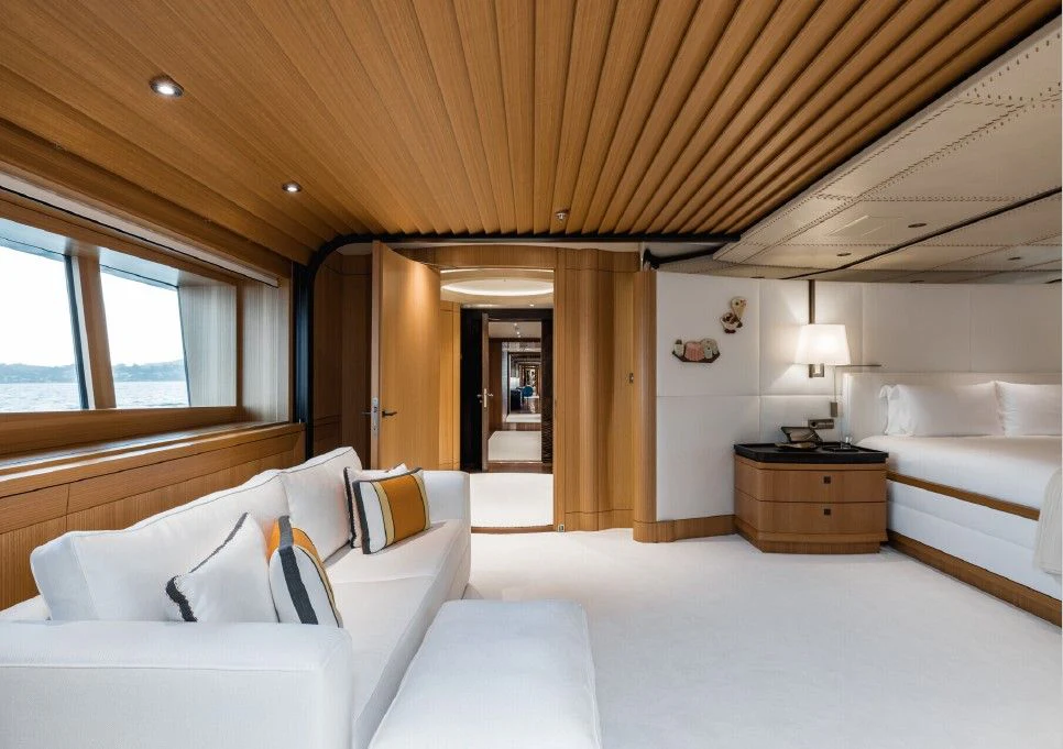 a bedroom with a bed and a desk aboard VENTUM MARIS Yacht for Charter