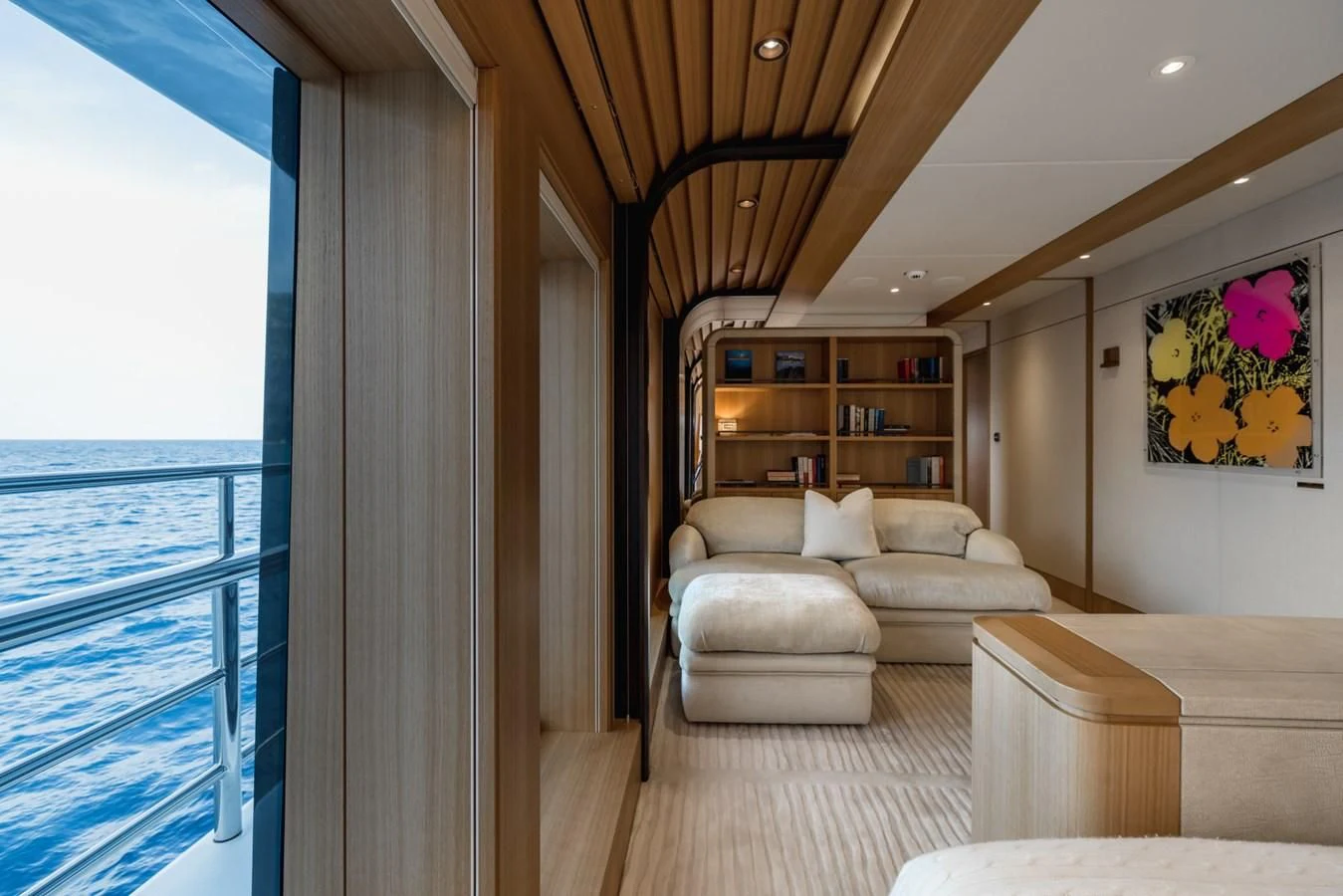 a living room with a couch and a bookcase aboard VENTUM MARIS Yacht for Charter