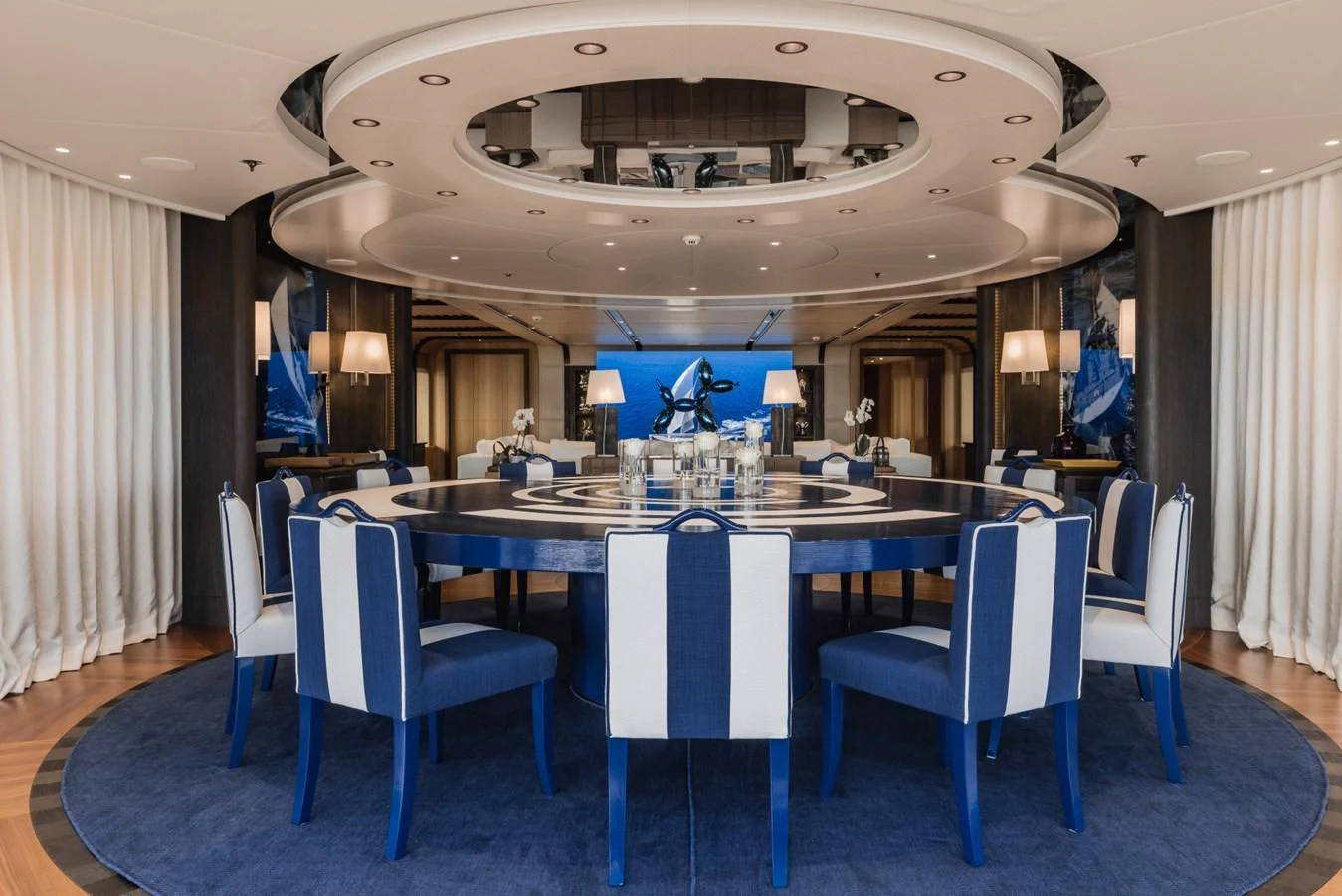 a large room with a table and chairs aboard VENTUM MARIS Yacht for Charter