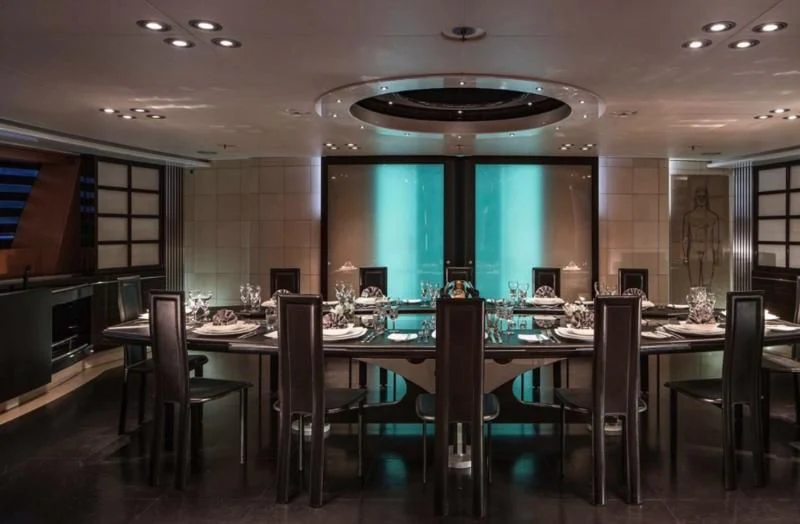a large room with a table and chairs aboard MALTESE FALCON Yacht for Sale