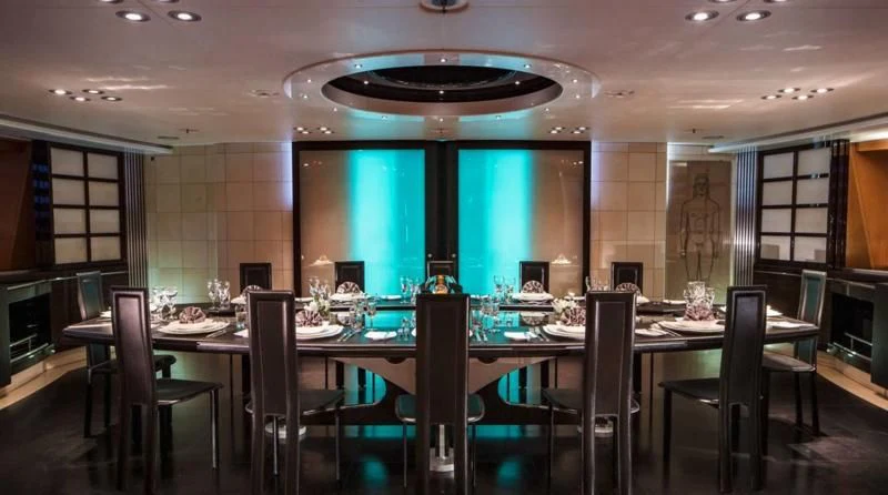 a large room with a table and chairs aboard MALTESE FALCON Yacht for Sale