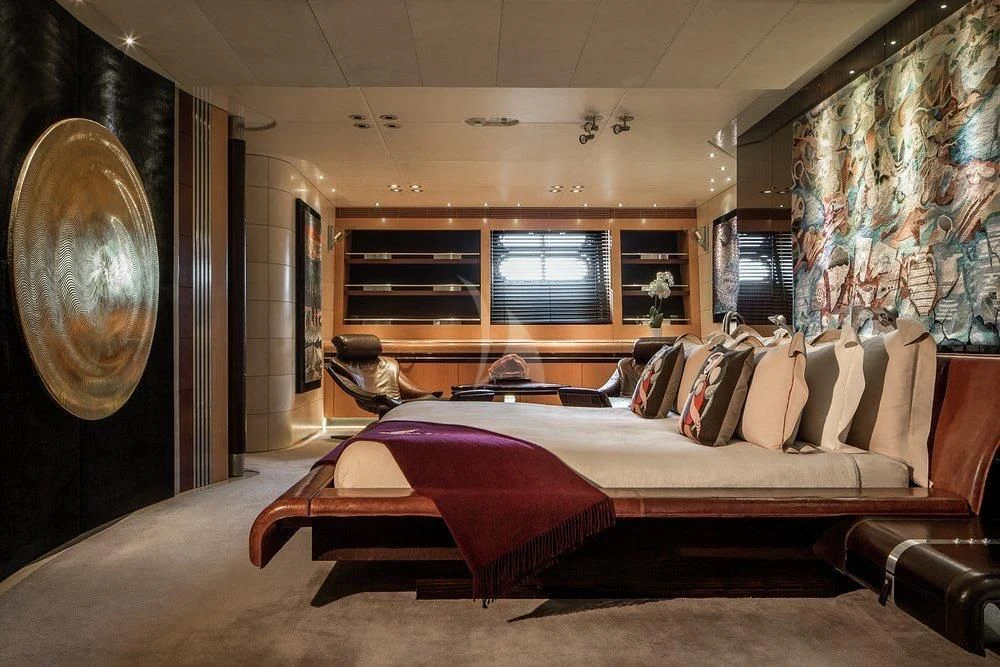 a room with a bed and a mirror aboard MALTESE FALCON Yacht for Sale