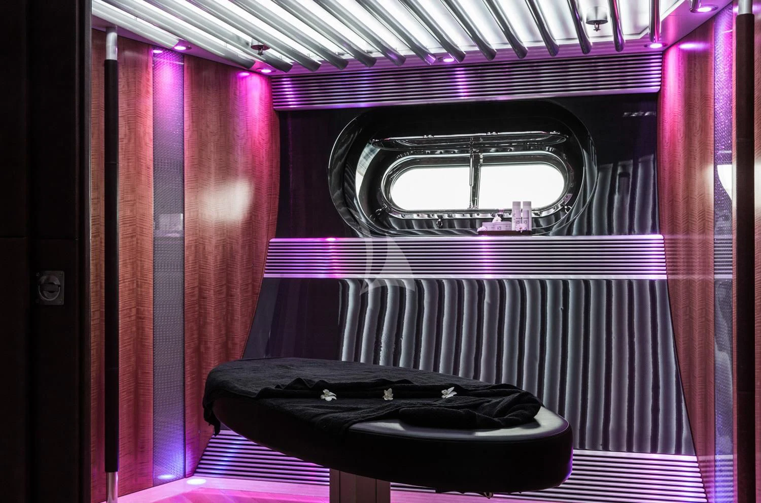 a black and red piano in a room with a window aboard MALTESE FALCON Yacht for Sale