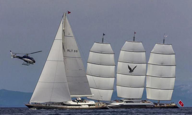 a helicopter flying over a group of sailboats aboard MALTESE FALCON Yacht for Sale