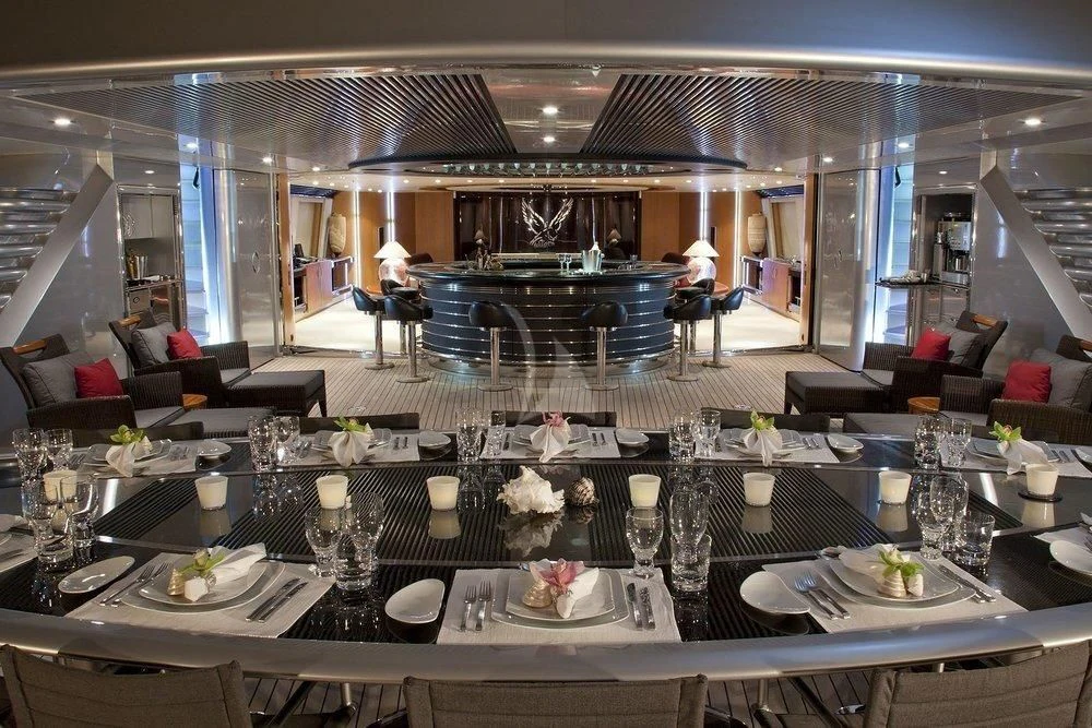 a large dining room with a large table set for a meal aboard MALTESE FALCON Yacht for Sale