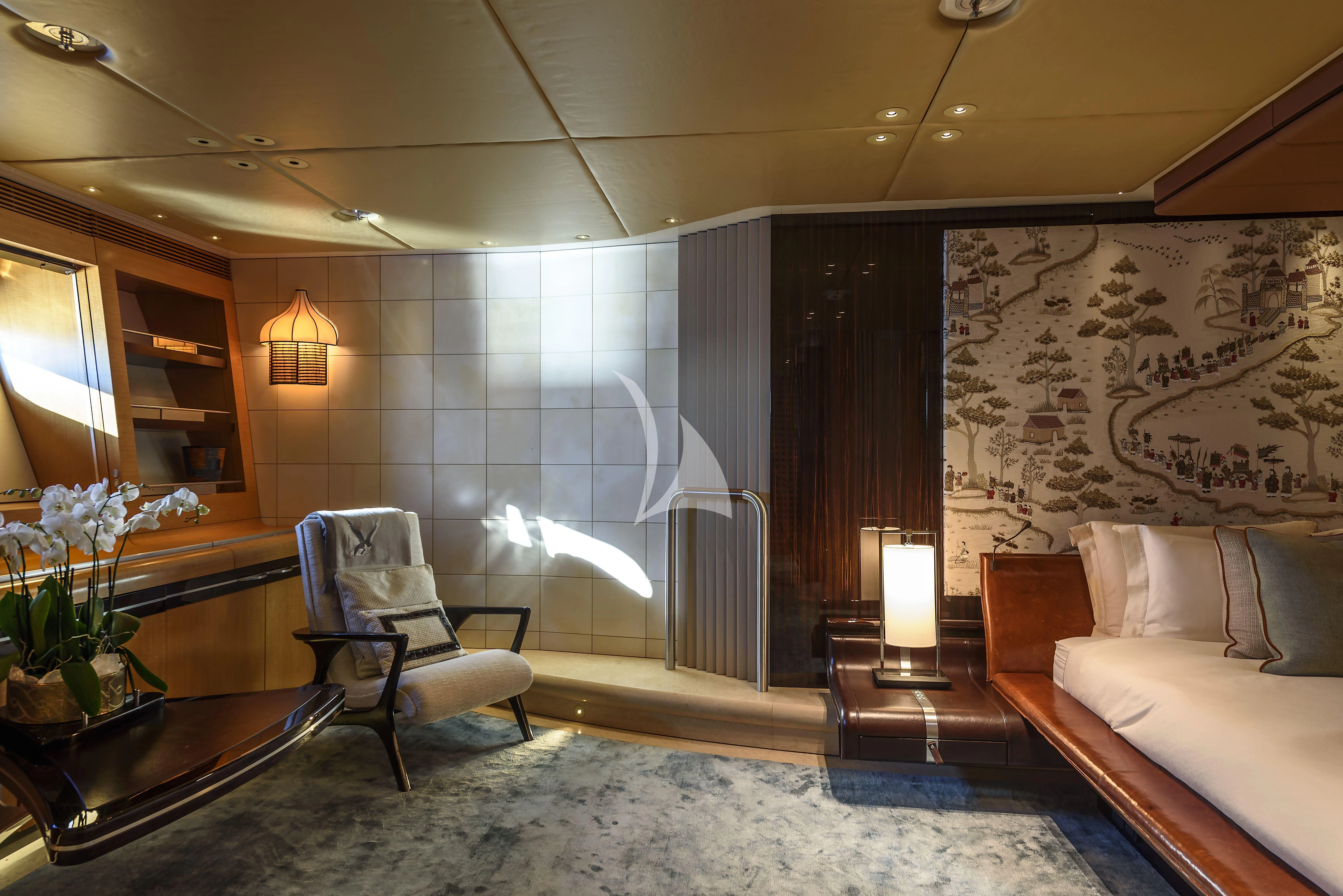 a room with a bed and a chair aboard MALTESE FALCON Yacht for Sale