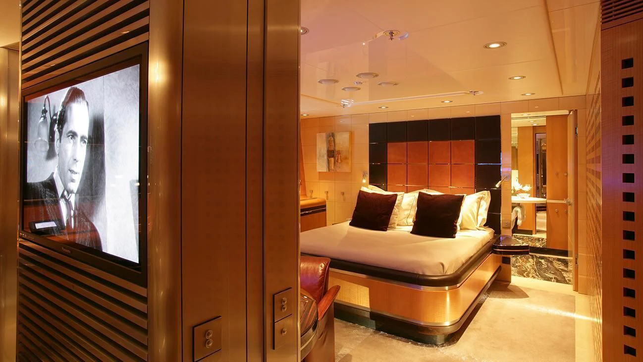 a room with a bed and a mirror aboard MALTESE FALCON Yacht for Sale