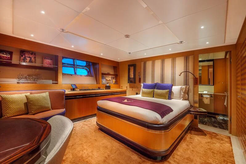 a room with a bed and a couch aboard MALTESE FALCON Yacht for Sale