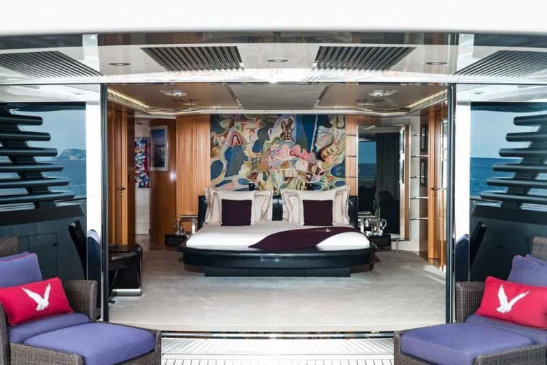 a room with a bed and a couch aboard MALTESE FALCON Yacht for Sale