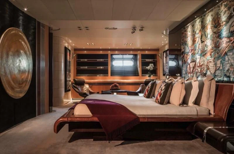 a room with a bed and a mirror aboard MALTESE FALCON Yacht for Sale