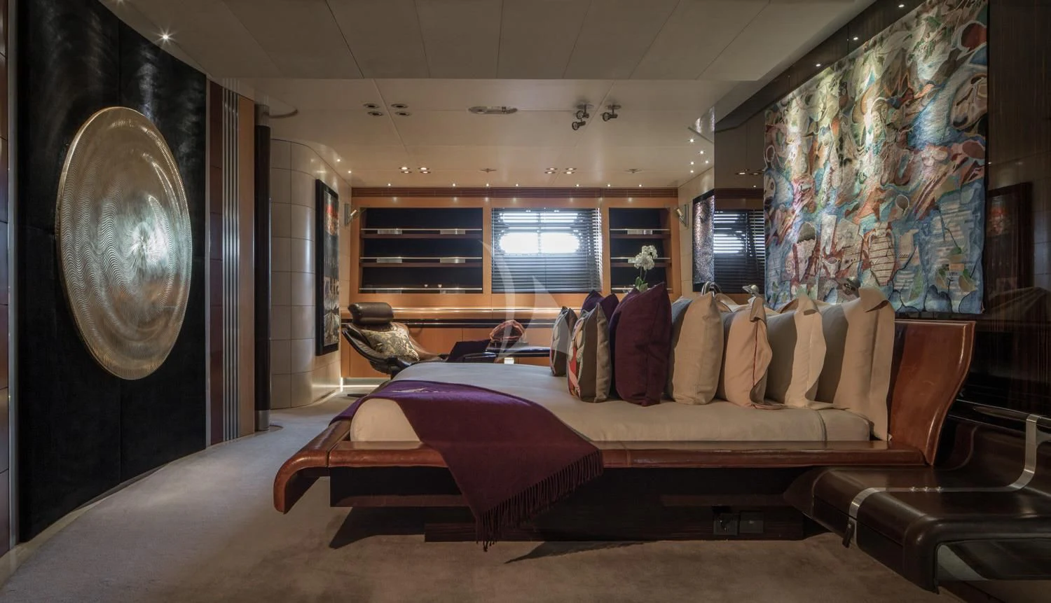 a room with a bed and a large mirror aboard MALTESE FALCON Yacht for Sale