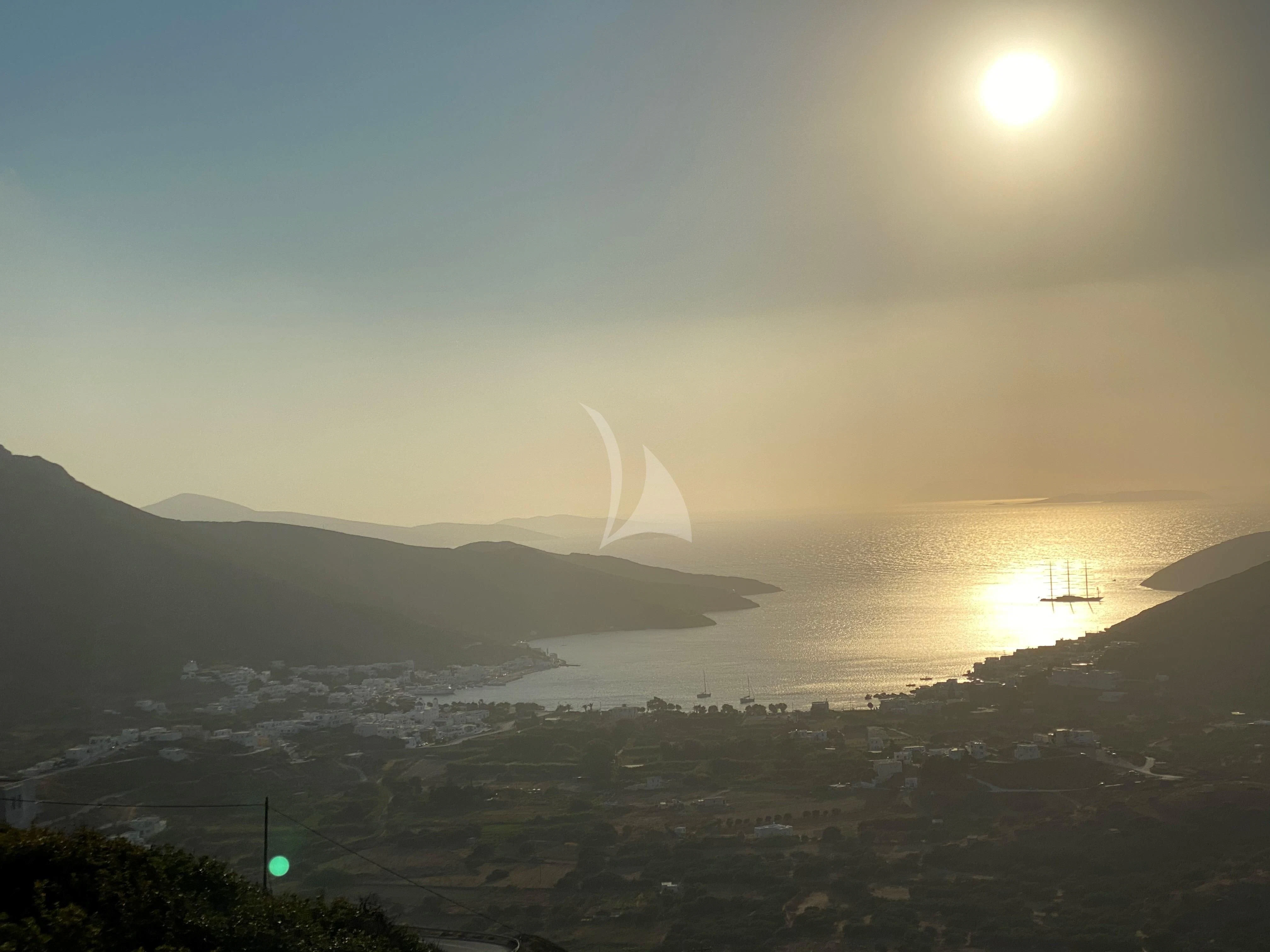 a landscape with a body of water and a mountain in the background aboard MALTESE FALCON Yacht for Sale
