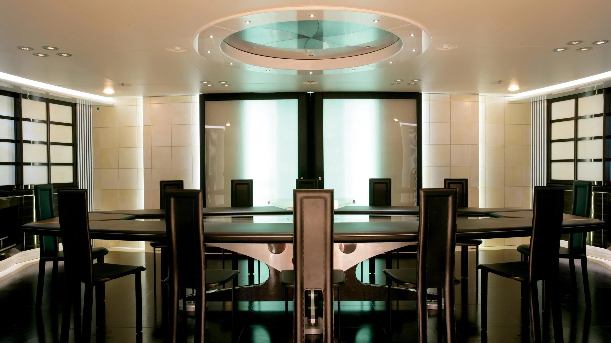 a room with a large table and chairs aboard MALTESE FALCON Yacht for Sale