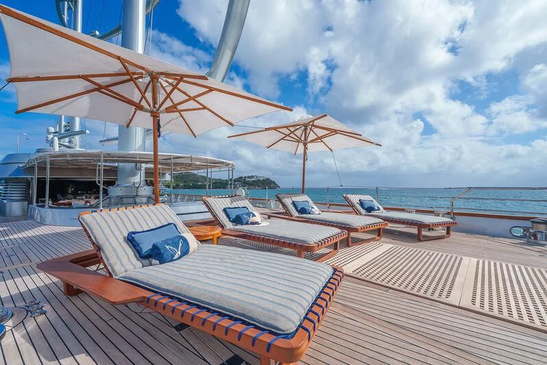 a deck with a large umbrella aboard MALTESE FALCON Yacht for Sale