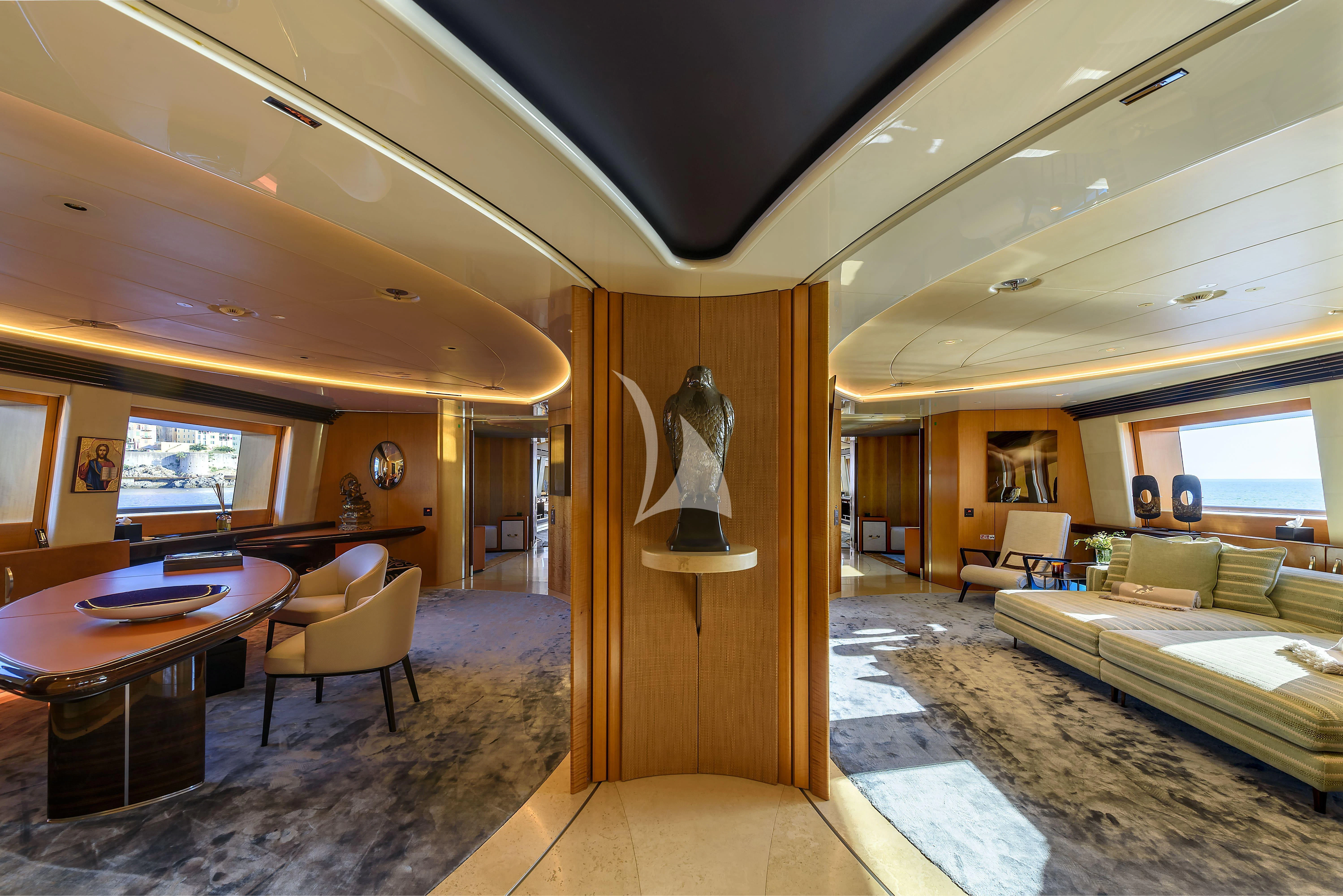 a living room with a couch and a table aboard MALTESE FALCON Yacht for Sale