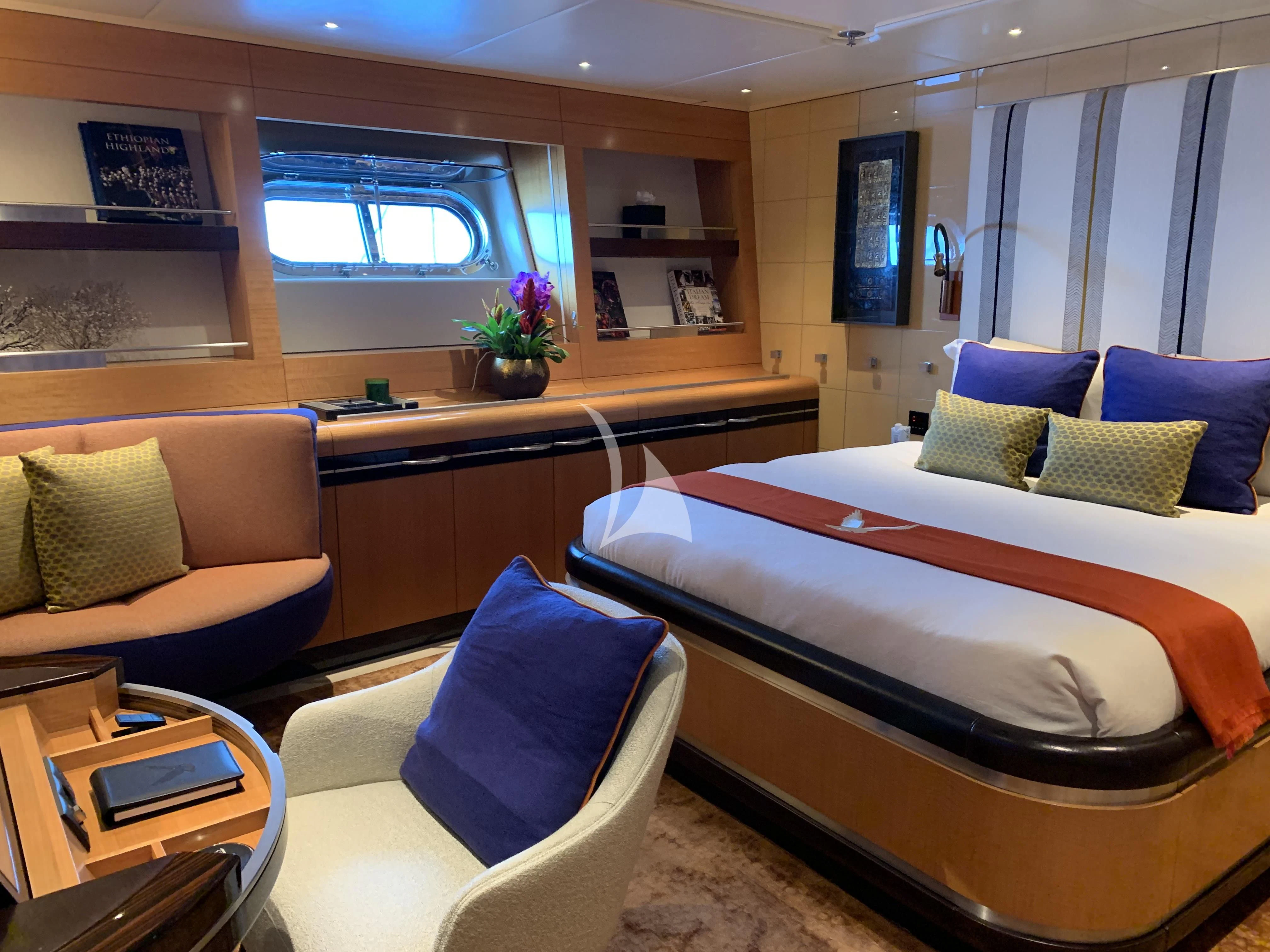 a room with a bed and a couch aboard MALTESE FALCON Yacht for Sale