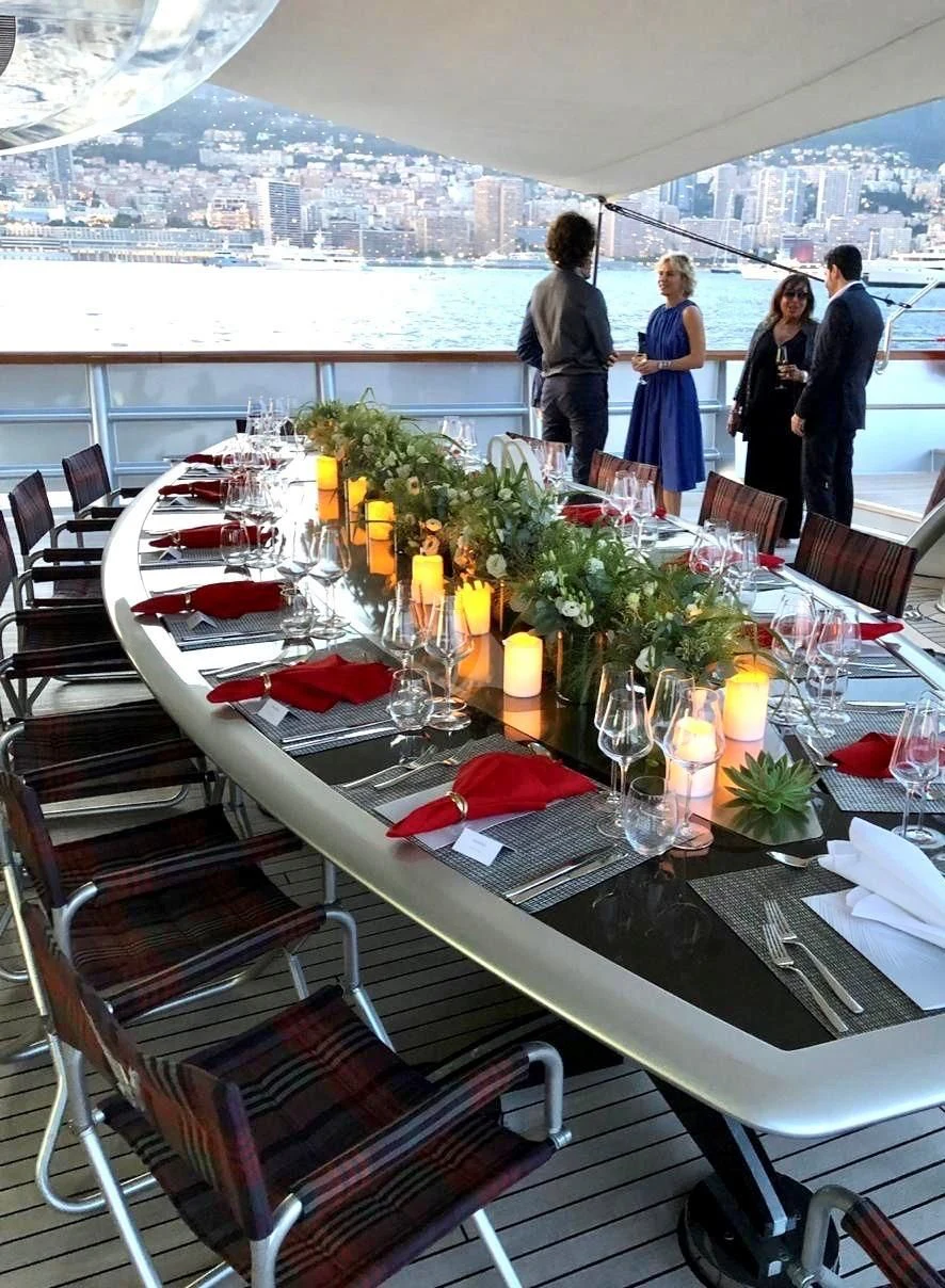 a table with glasses and food on it aboard MALTESE FALCON Yacht for Sale