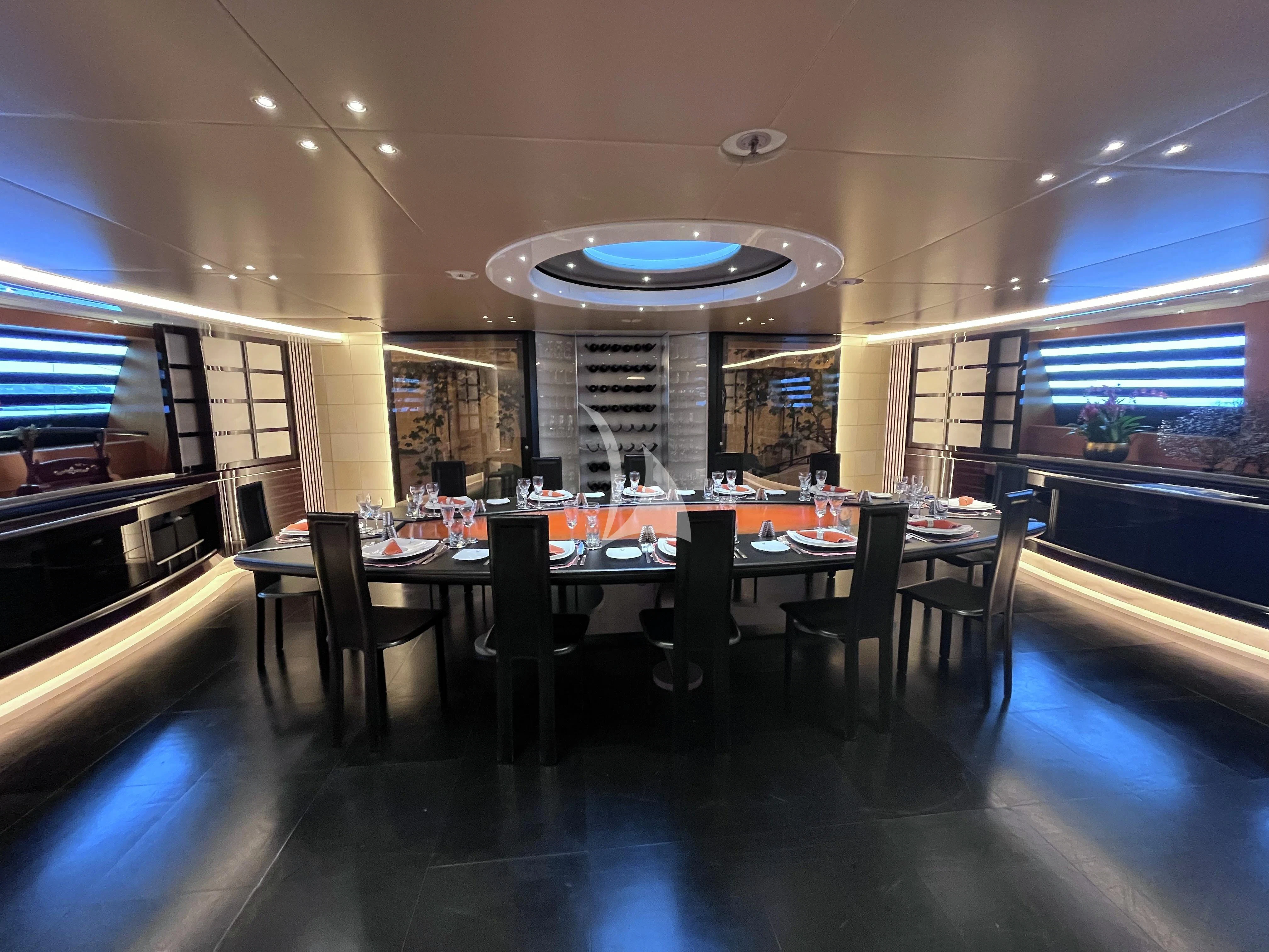 a large room with a table and chairs aboard MALTESE FALCON Yacht for Sale