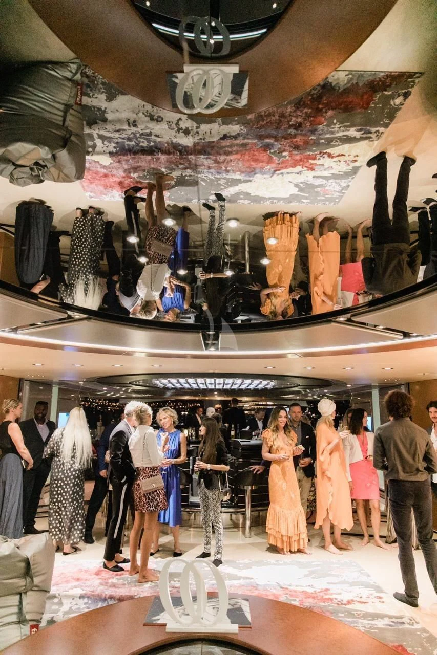 a group of people in a room with a display of shoes aboard MALTESE FALCON Yacht for Sale