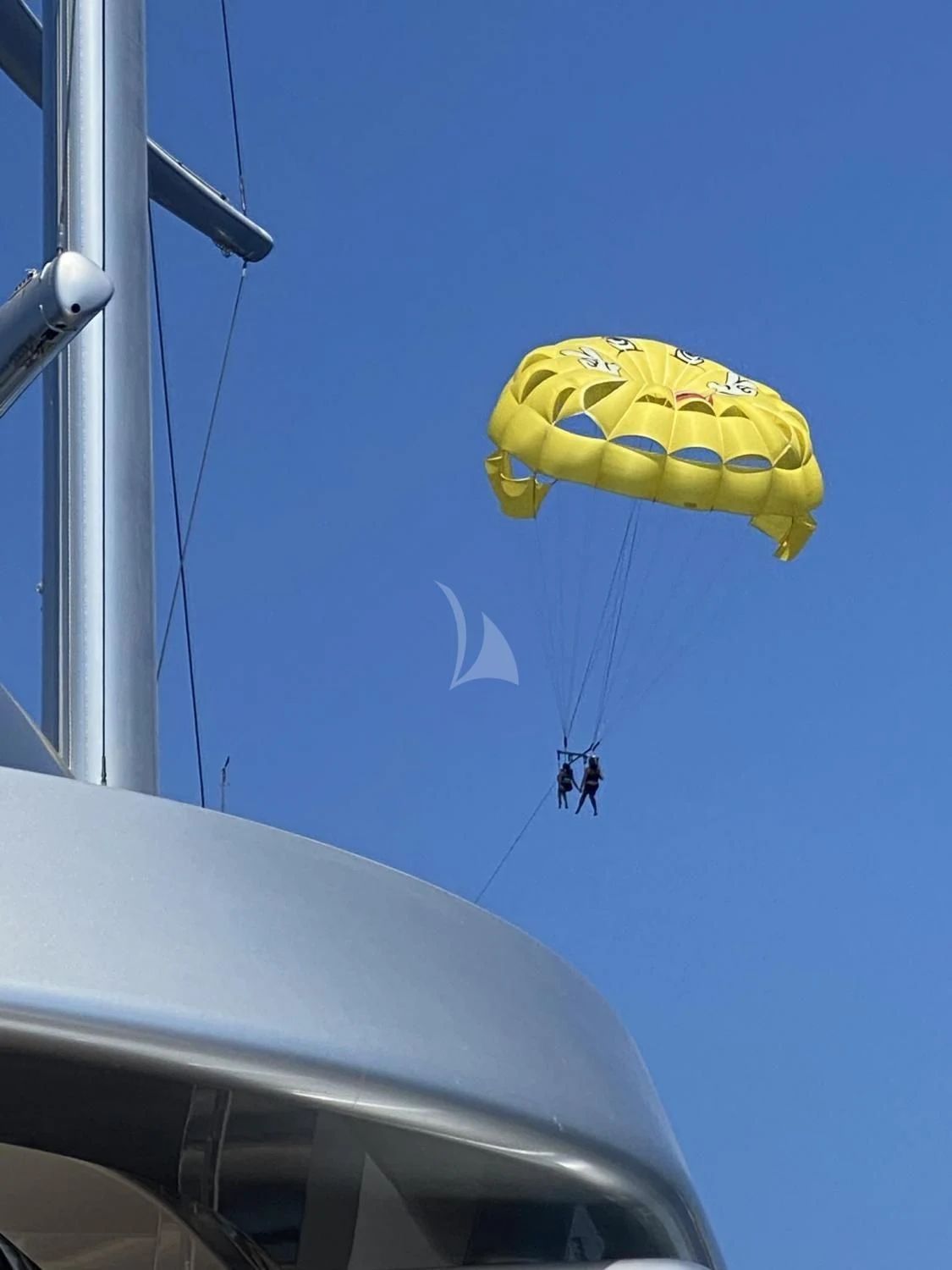 a yellow parachute in the sky aboard MALTESE FALCON Yacht for Sale