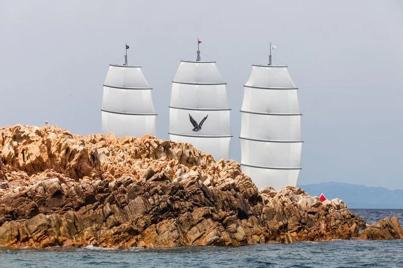 a couple of white boats on a rocky shore aboard MALTESE FALCON Yacht for Sale