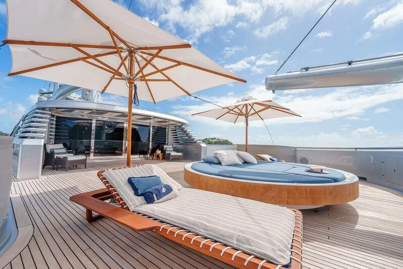 a deck with a large umbrella aboard MALTESE FALCON Yacht for Sale