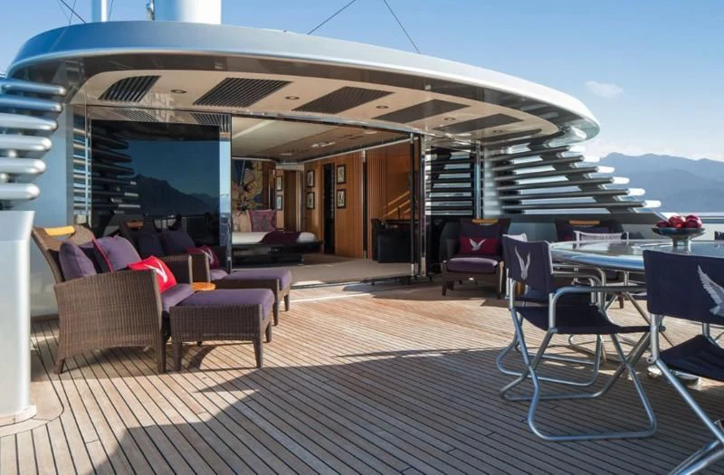 a deck with a table and chairs aboard MALTESE FALCON Yacht for Sale