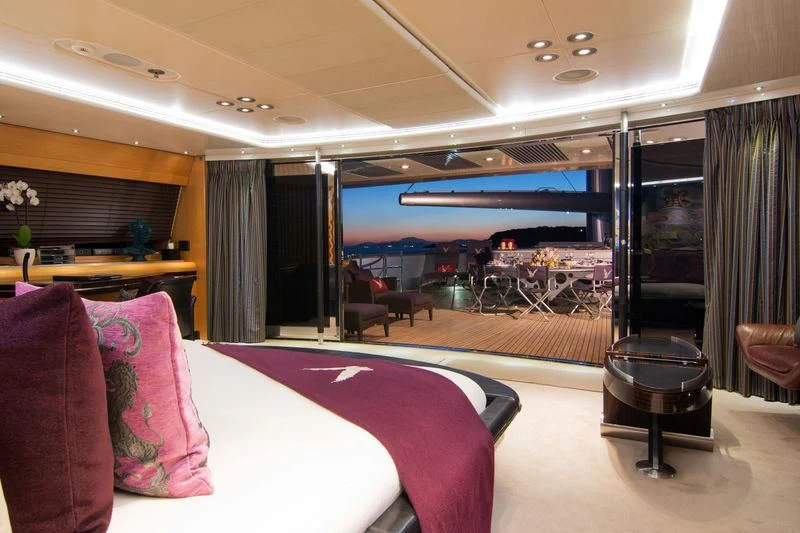 a room with a bed and a table aboard MALTESE FALCON Yacht for Sale